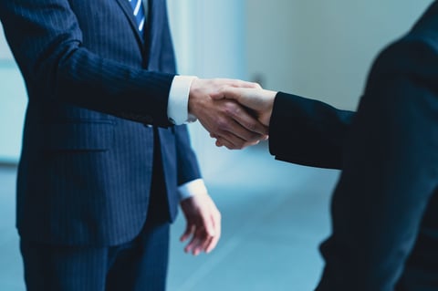 Business professionals shaking hands in partnership agreement